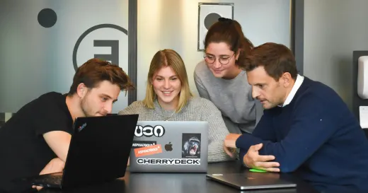 Representation of team discussing on laptop